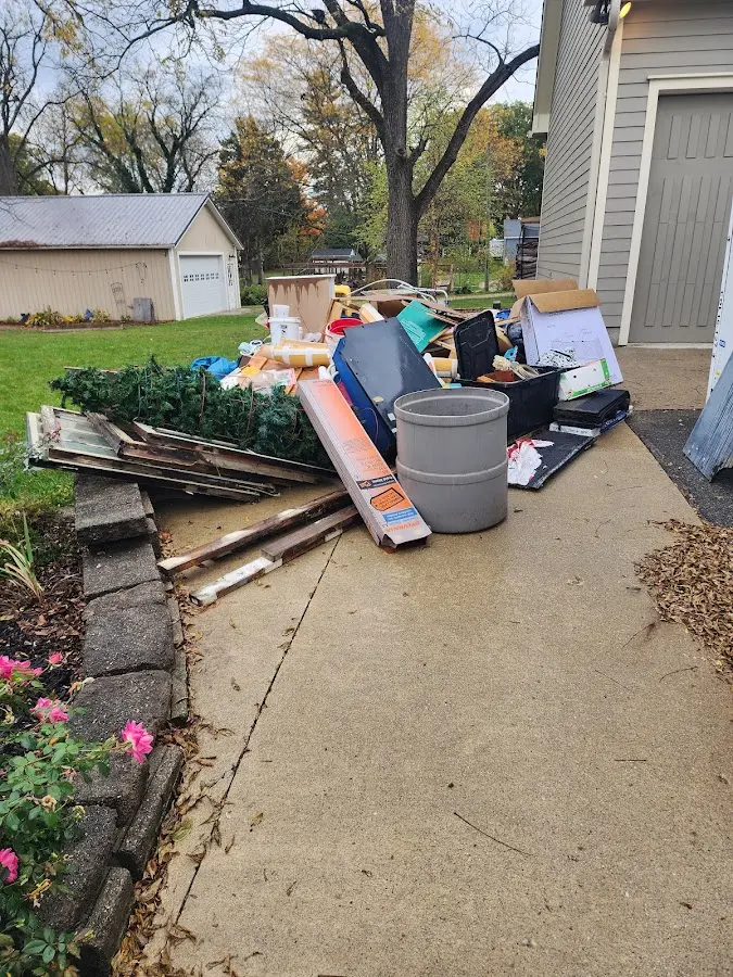 Dumpster being loaded with debris for Estate Cleanout Dumpster Rental in Payette
